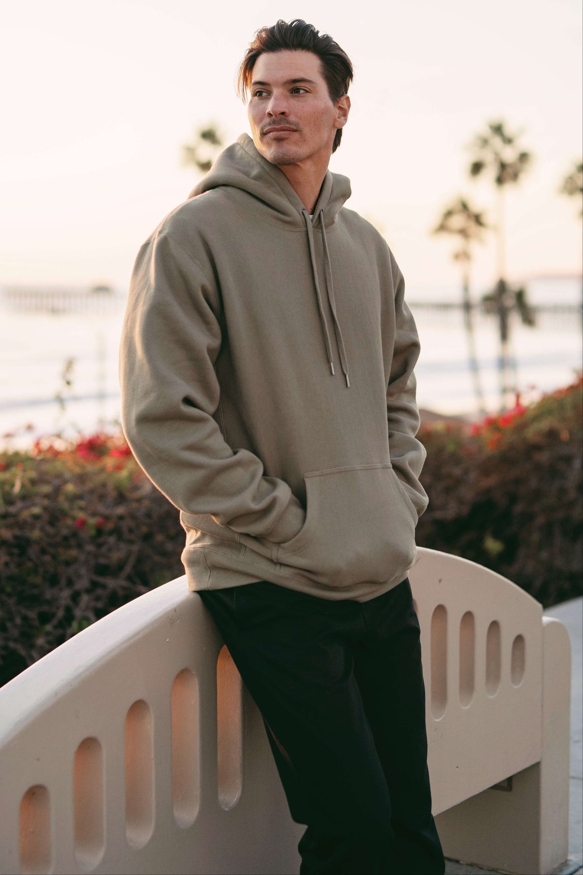 A man wearing an olive heavyweight hoodie from Clothes by Graham